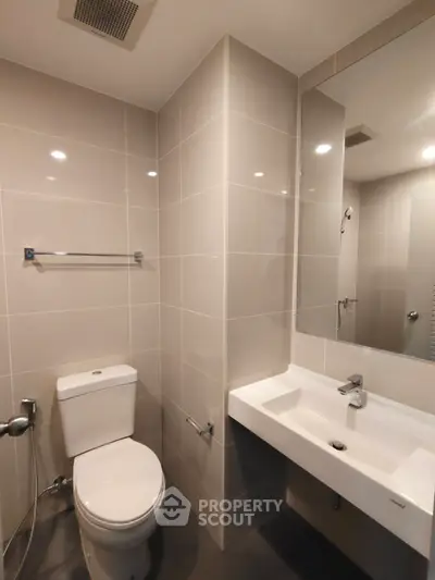 Modern bathroom with sleek fixtures and neutral tiles