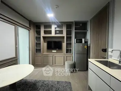 Modern living room with built-in TV unit and compact kitchen area