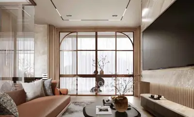 Luxurious modern living room with elegant decor and large flat-screen TV.