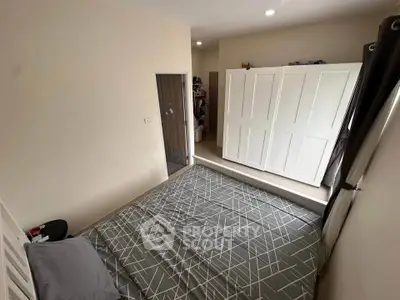 Cozy bedroom with modern wardrobe and stylish bedding