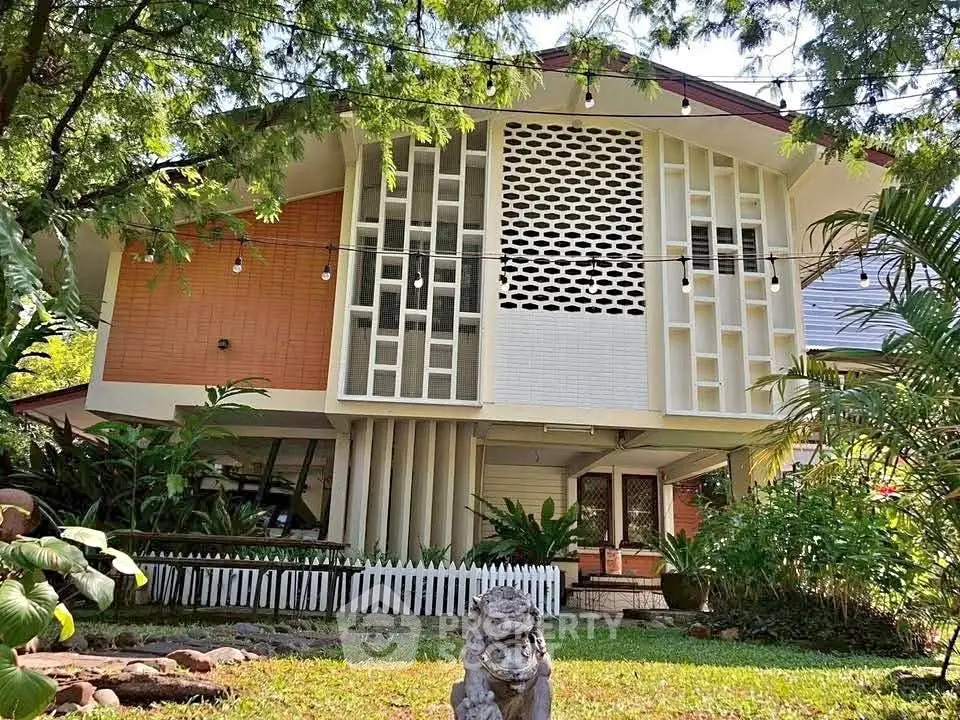 Charming mid-century modern home with lush garden and unique architectural design.
