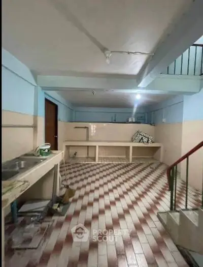 Spacious basement area with tiled flooring and potential for customization.