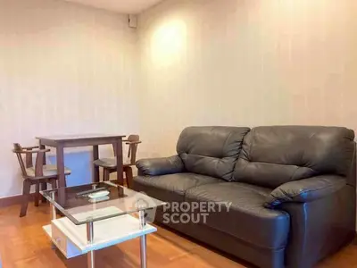 Cozy living room with leather sofa and modern glass coffee table
