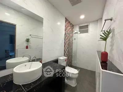 Modern bathroom with stylish fixtures and elegant marble countertop.