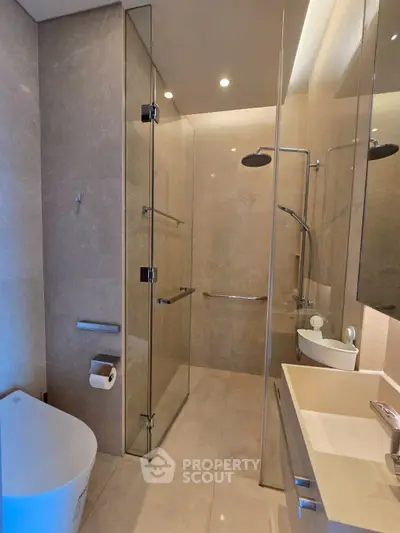 Luxurious modern bathroom with glass shower and elegant fixtures