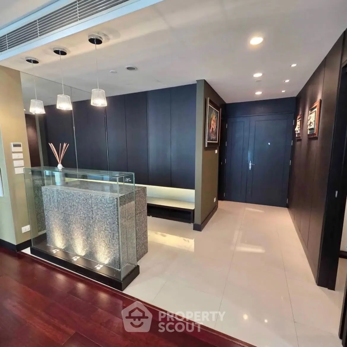 Luxurious modern apartment entrance with elegant lighting and sleek design.