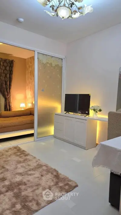 Cozy living room with modern decor and sliding door to bedroom