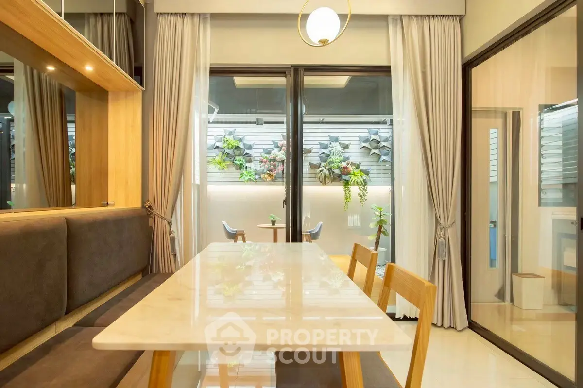 Elegant dining area with marble table and garden view, perfect for modern living.