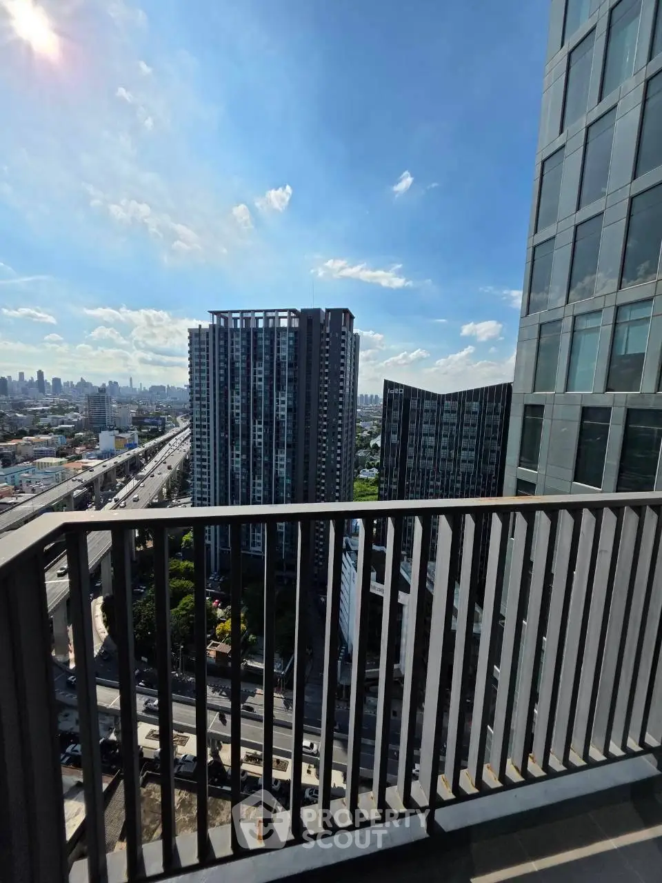 Stunning cityscape view from a modern high-rise balcony, perfect for urban living enthusiasts.
