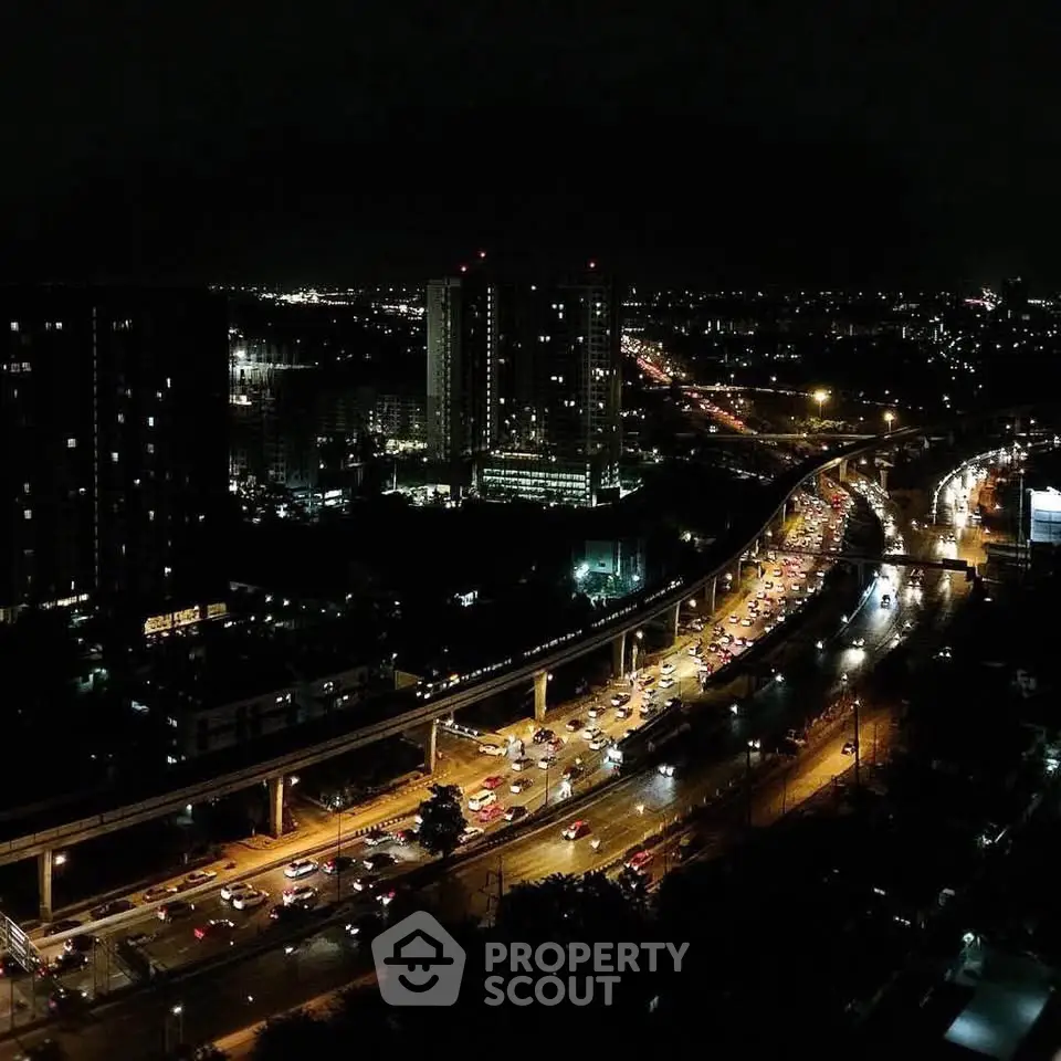 Stunning nighttime cityscape view with illuminated roads and high-rise buildings.