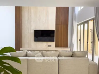 Luxurious modern living room with elegant decor and large TV, perfect for relaxation and entertainment.