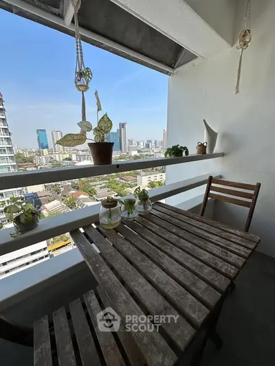 Charming balcony with wooden table and city view, perfect for relaxation and enjoying the skyline.