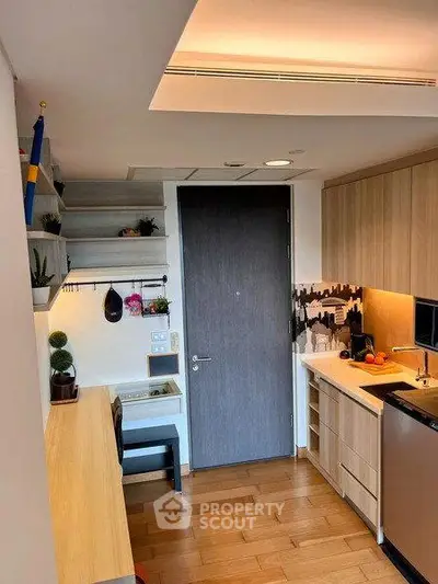Modern kitchen with wooden cabinets and sleek appliances in a compact layout.