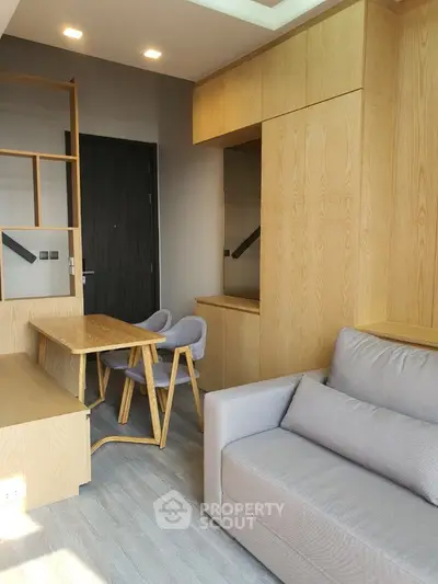 Modern living room with wooden furniture and cozy gray sofa