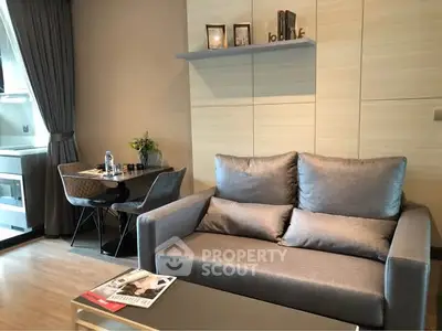 Modern living room with stylish sofa and dining area in a cozy apartment.