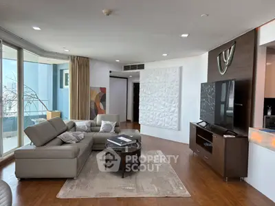 Spacious modern living room with large windows and stylish decor in luxury apartment.