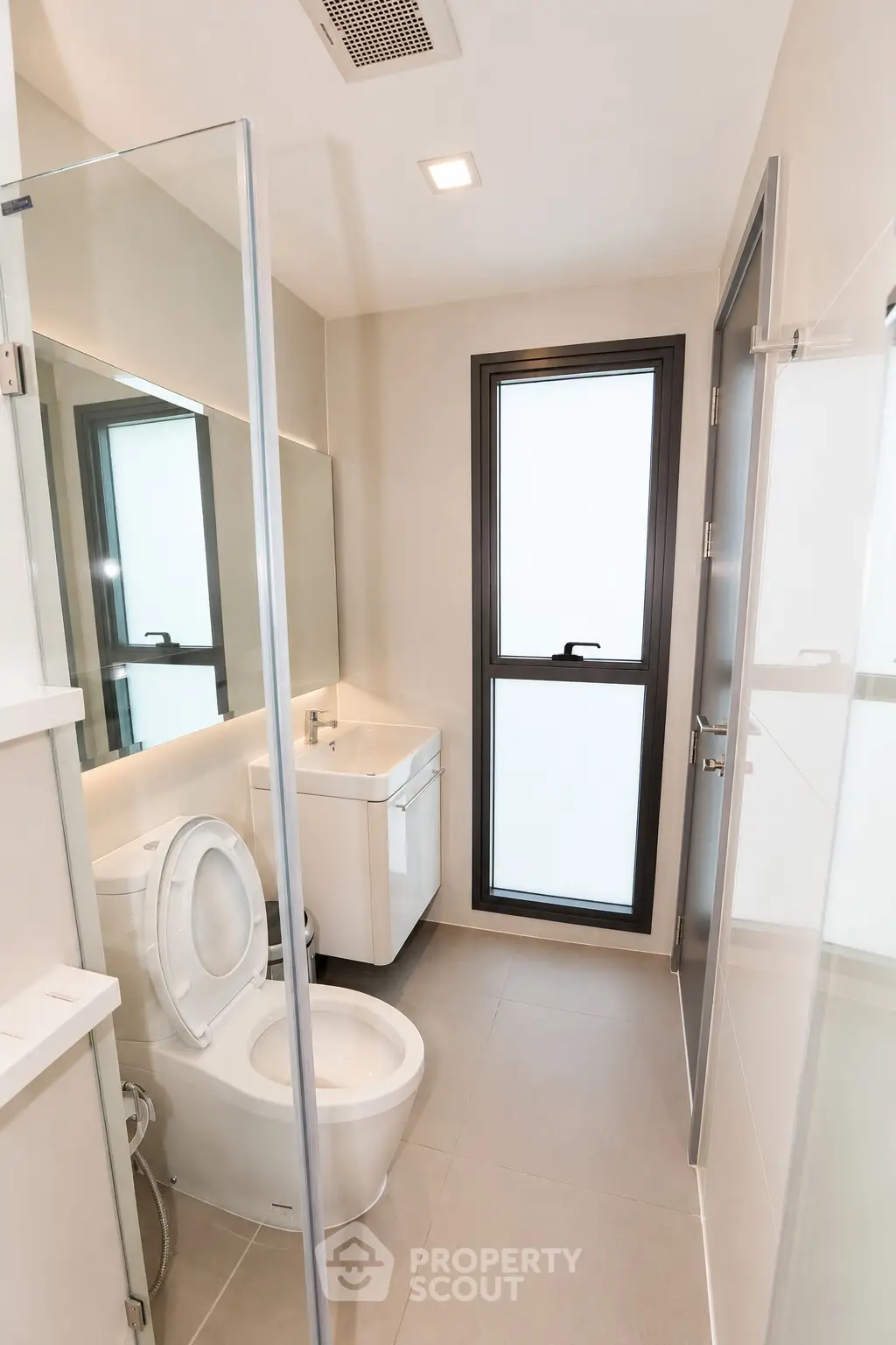 Modern bathroom with sleek fixtures and large window for natural light.
