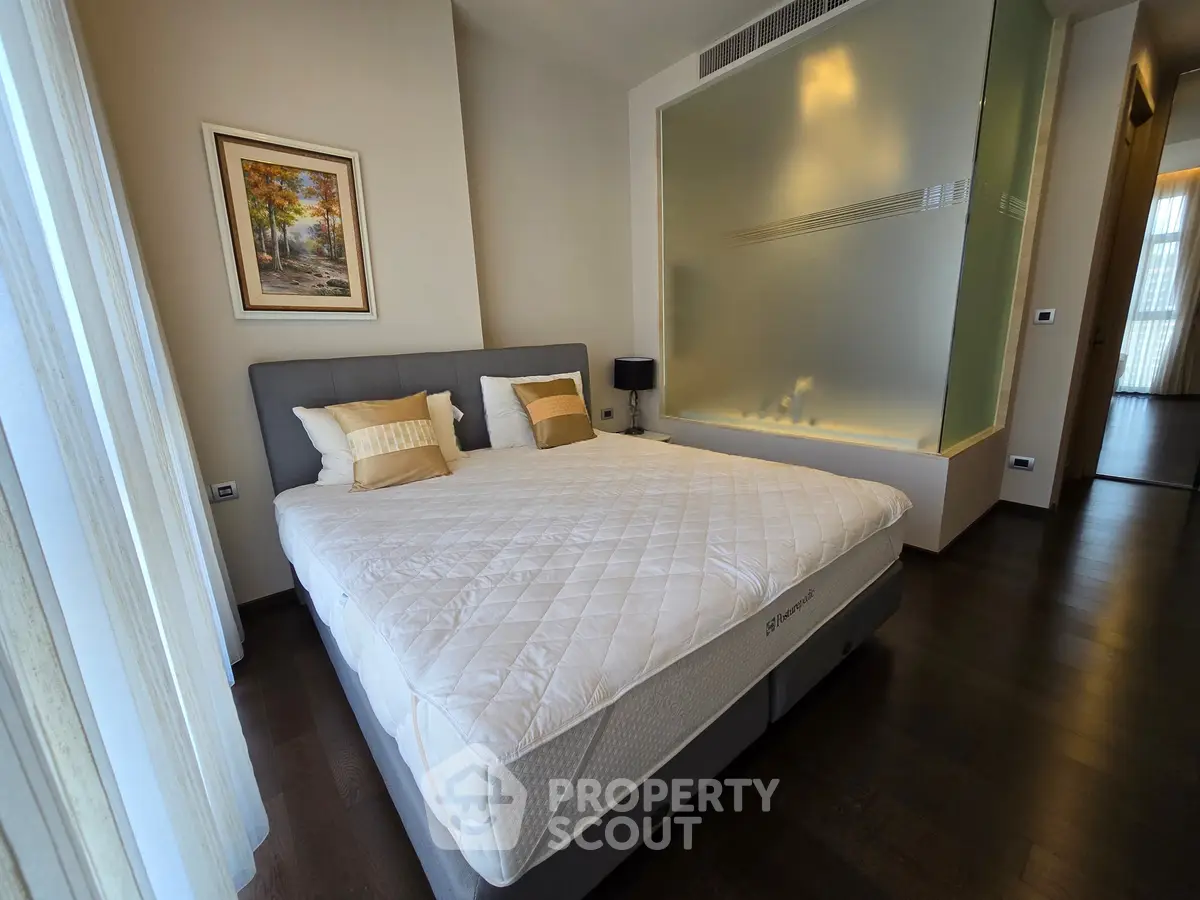 Luxurious bedroom with elegant decor and large comfortable bed in modern apartment.