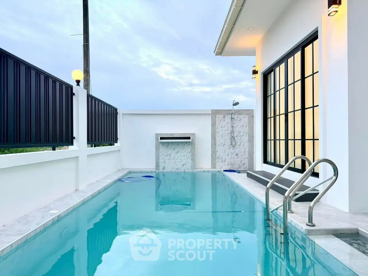 Luxurious modern home with private pool and elegant outdoor shower area.