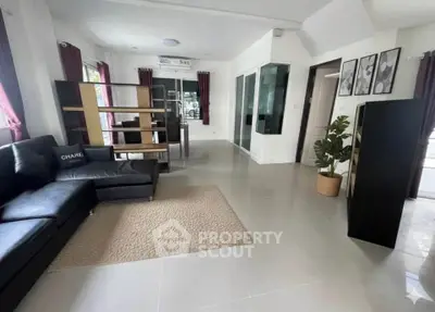 Spacious modern living room with sleek furniture and large windows for natural light.