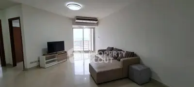 Spacious living room with modern sofa and TV, featuring a large window with city view.