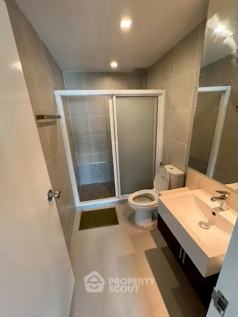 Modern bathroom with sleek fixtures and spacious shower area