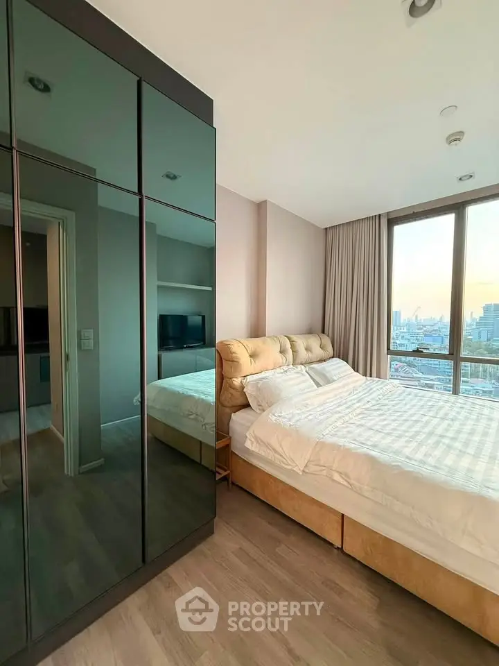 Modern bedroom with city view, featuring sleek wardrobe and cozy bed in a high-rise apartment.