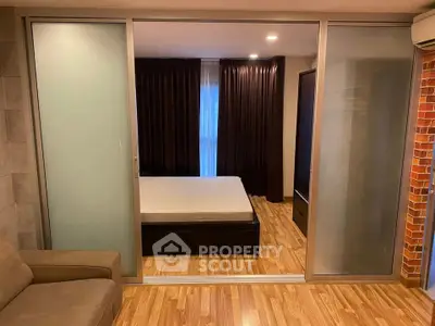Modern bedroom with sliding glass doors and cozy wooden flooring