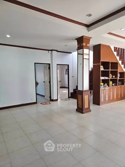 Spacious living room with elegant wooden accents and open layout, perfect for modern living.
