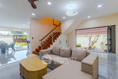 Spacious modern living room with open layout and stylish staircase