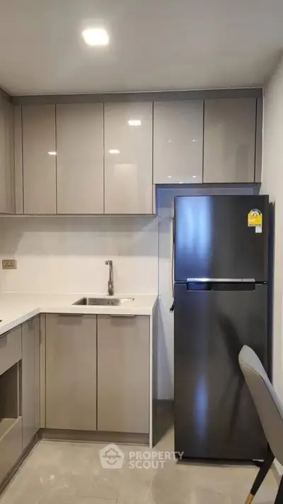 Modern kitchen with sleek cabinets and stainless steel fridge