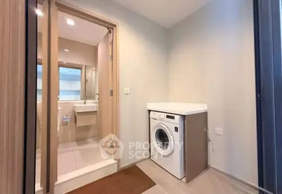 Modern bathroom with washing machine and sleek design