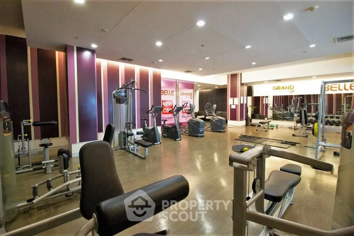 Spacious modern gym with state-of-the-art equipment and stylish interior design.