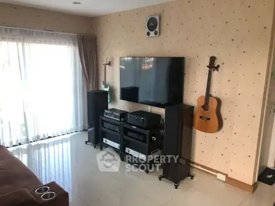 Modern living room with entertainment system and wall-mounted TV