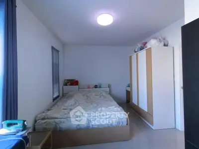 Spacious bedroom with modern wardrobe and cozy bed setup