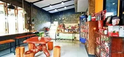 Charming cafe interior with rustic wooden furniture and modern decor, perfect for a cozy dining experience.