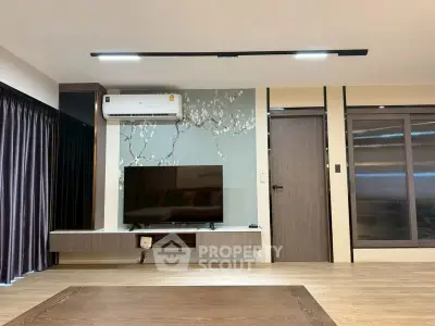 Modern living room with wall-mounted TV and stylish decor