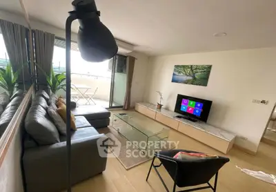 Modern living room with balcony, stylish furniture, and natural light
