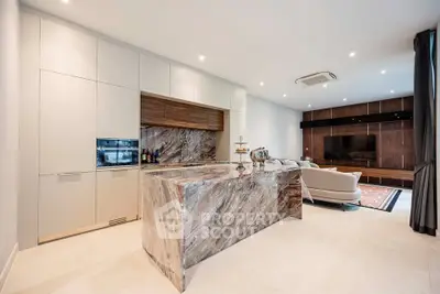 Luxurious open-plan living room with modern kitchen and elegant marble island