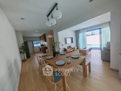 Spacious open-plan living and dining area with modern decor and natural light.