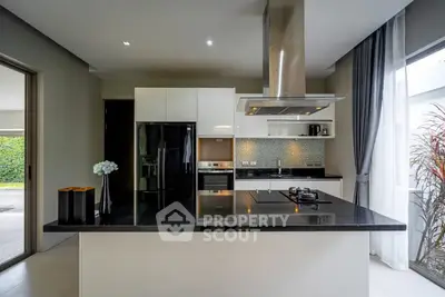 Modern kitchen with sleek black countertops and stainless steel appliances