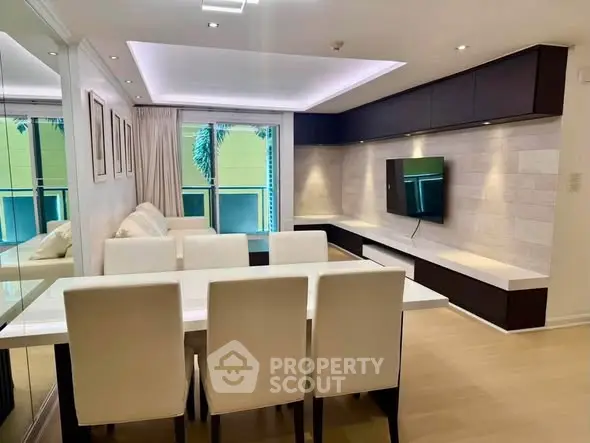 Modern living room with sleek furniture and wall-mounted TV in a stylish apartment.