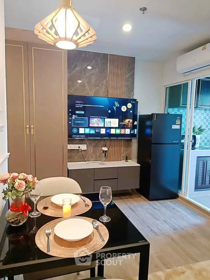 Modern living room with stylish decor, wall-mounted TV, and elegant dining setup in a cozy apartment.