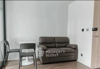 Cozy modern living room with a compact sofa and dining set, perfect for urban living.