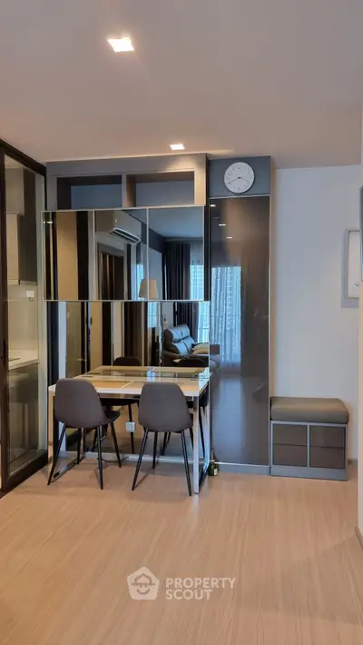 Modern living room with stylish furniture and mirrored wall panels