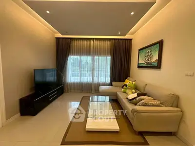 Elegant living room with modern decor, large window, and cozy seating area.