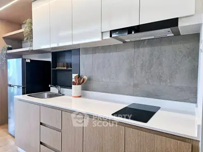Modern kitchen with sleek cabinetry and built-in appliances