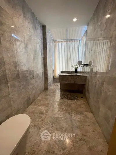 Luxurious marble bathroom with modern fixtures and natural light