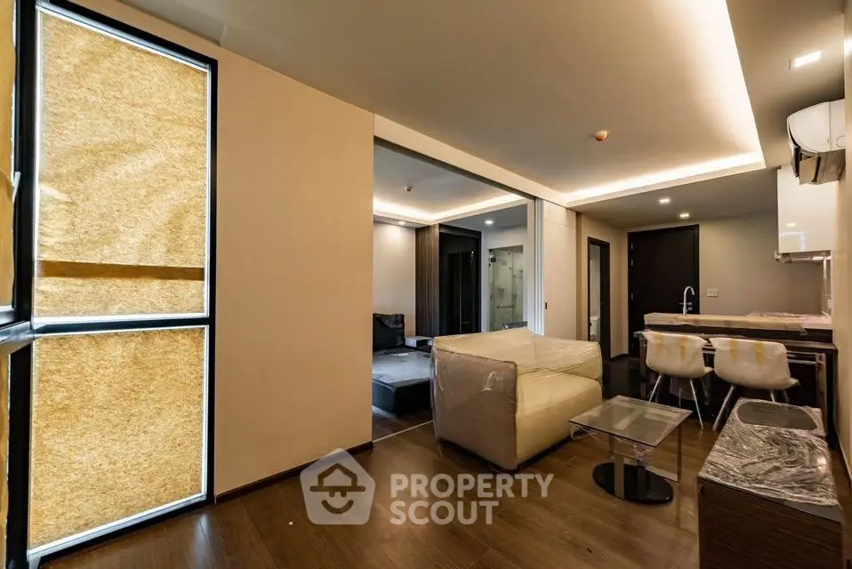 Modern open-plan living room with stylish furniture and ambient lighting