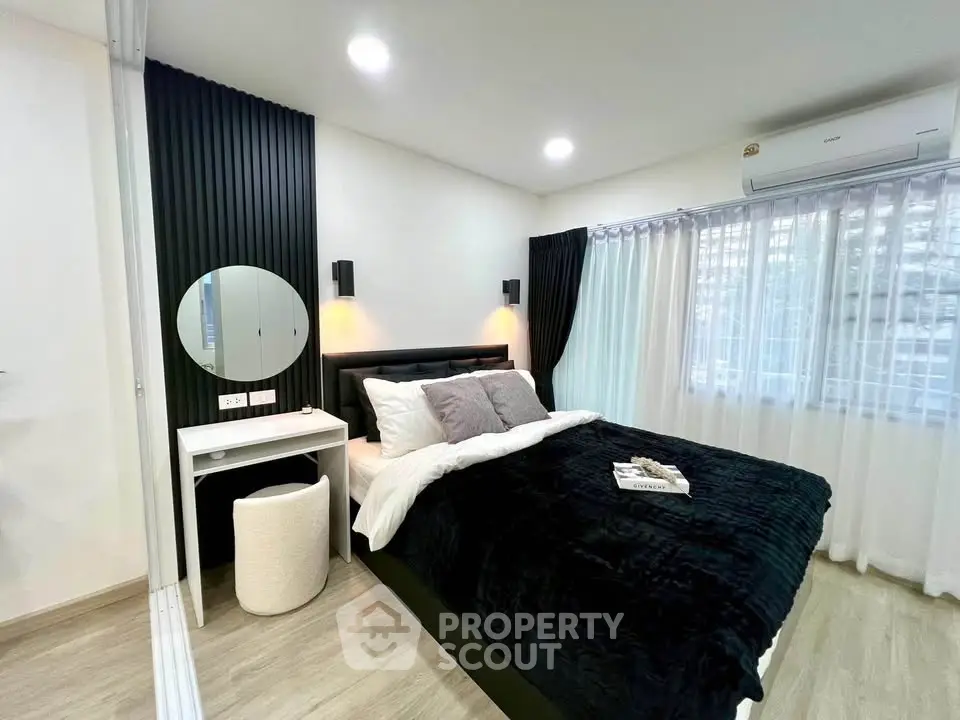 Modern bedroom with stylish decor and natural light